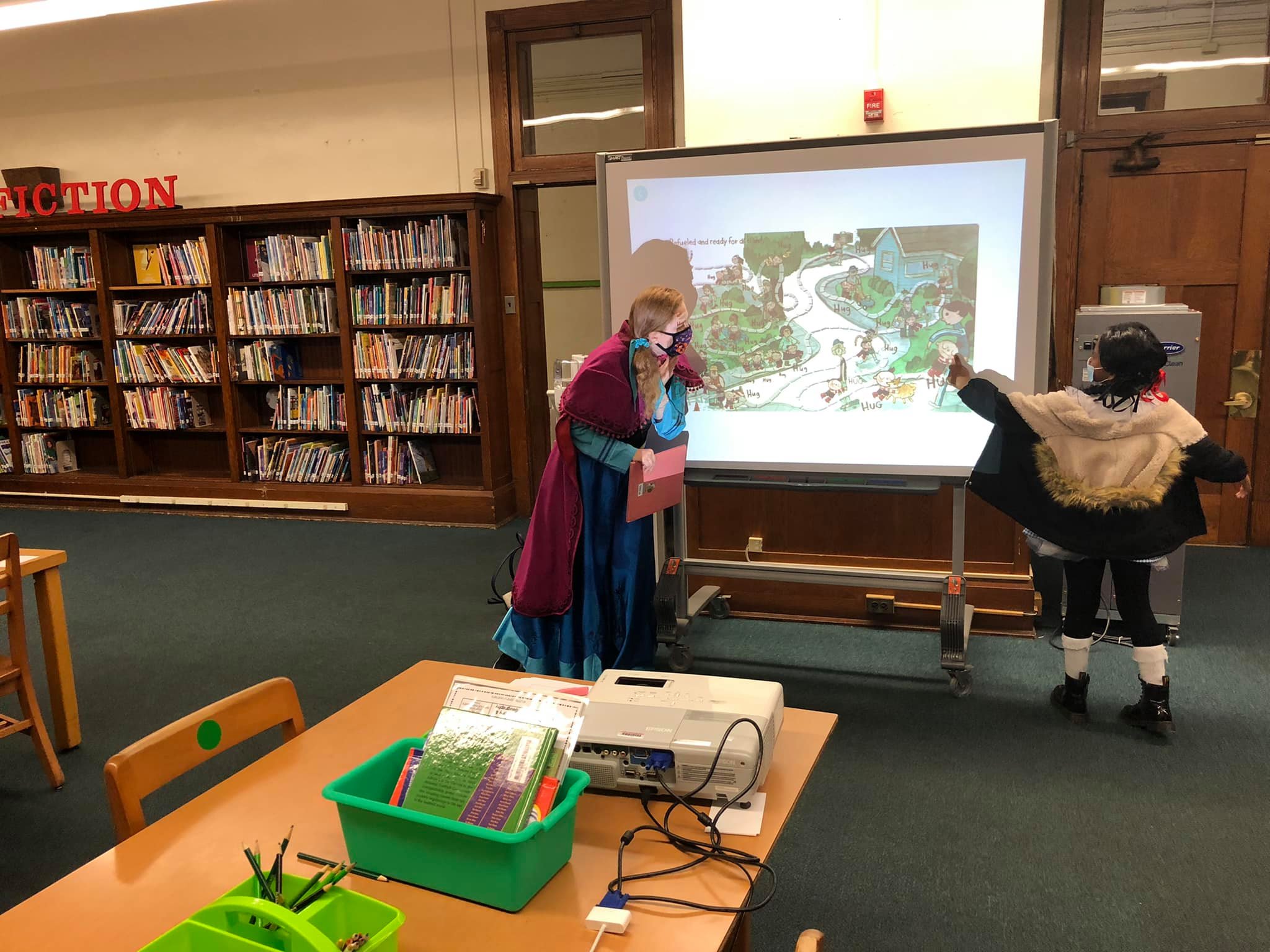 Carrie and student discuss a scene from a book