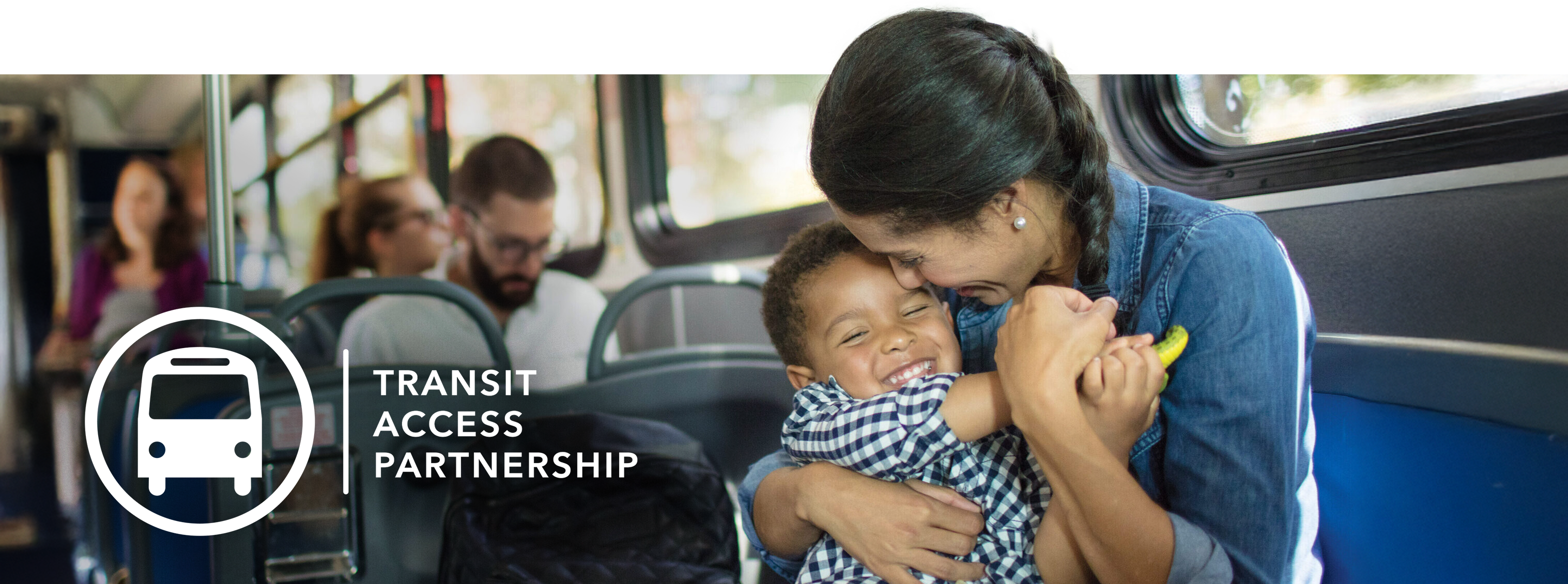 a parent and child riding the bus with free fare, supported by TAP